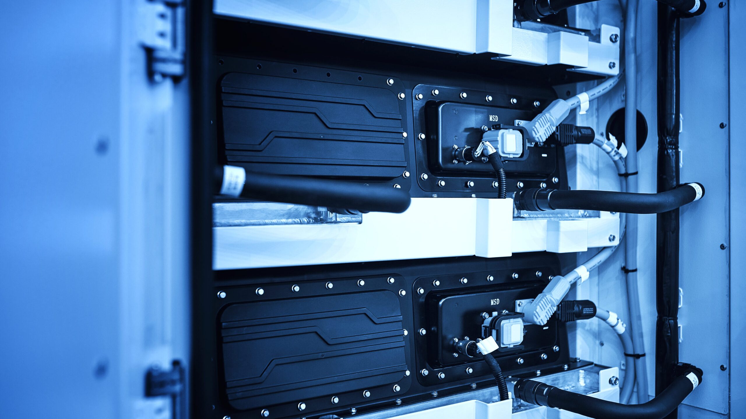 Close-up of several lithium-Ion battery modules at shelf.